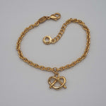 Carica l'immagine nel visualizzatore di Gallery, Bracciale Dolcetto CACAO Jewels in ottone placcato in oro 18 carati con pendente a cuore a nodo.
