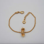 Carica l'immagine nel visualizzatore di Gallery, Bracciale Dono CACAO Jewels in ottone placcato in oro 18 carati con fiocco centrale.
